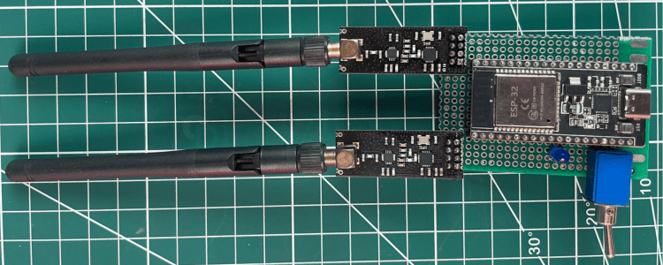 Brouilleur Bluetooth ESP32 entièrement assemblé sur carte perforée montrant deux modules NRF24L01 PA+LNA, une batterie LiPo, un interrupteur à bascule et un voyant d'état
